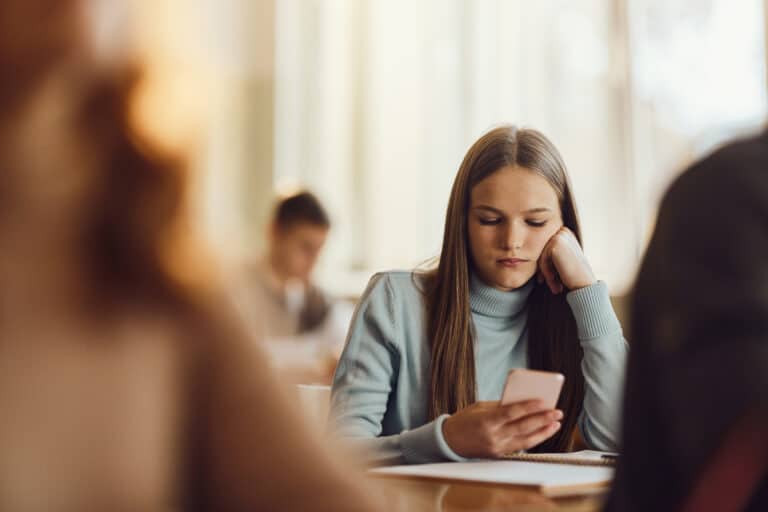 Student using phone in classroom
